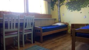 a room with two chairs and a tree on the wall at Beneport Peipsi Guest House in Mehikoorma
