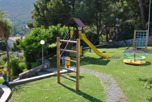 a playground with a slide in the grass at Hotel Ristorante Borgo La Tana in Maratea