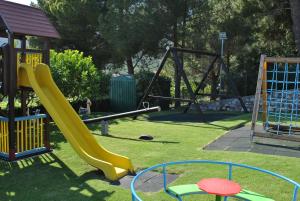 a playground with a slide and a swing set at Hotel Ristorante Borgo La Tana in Maratea