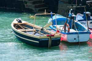 
a small boat in a body of water at The Old Inn in Mullion
