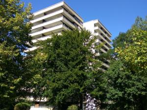 a tall white building with trees in front of it at Apartment Reichenbachstraße in Bad Reichenhall +5 photos