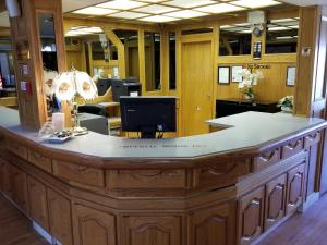 an office with a large counter with a reception desk at New Imperial Inn in Cold Lake