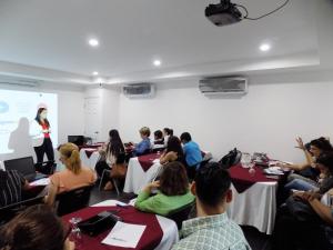 a group of people sitting at tables in a room at Hotel Los Pinos in Managua