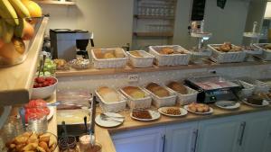 - un buffet composé de différents types de pain et de viennoiseries dans l'établissement Het Uilenbos, à De Koog