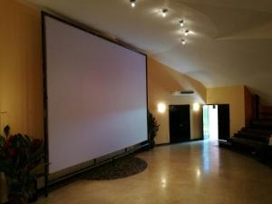 a large screen in a room with a large wall at Sarapiquis Rainforest Lodge in Sarapiquí