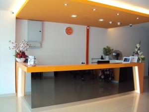 a desk in a room with a clock on the wall at GM City Hotel in Klang