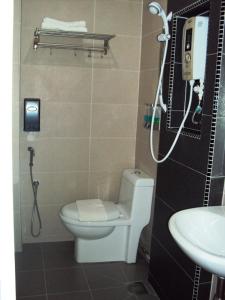 a bathroom with a toilet and a sink at GM City Hotel in Klang