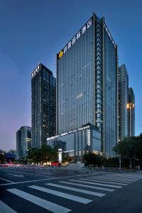 a large building in a city with tall buildings at Honder International Hotel in Guangzhou
