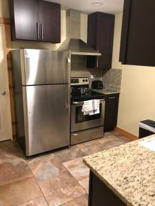 a kitchen with a stainless steel refrigerator and a stove at Farwell dream in Chicago