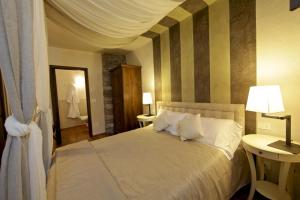 a hotel room with a large bed and a large window at Maison Bondaz & SPA privé in Aosta