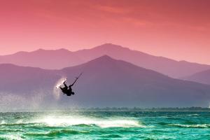 a person is in the air over the ocean at Seven Park Hotel Lake Como - Adults Only in Colico