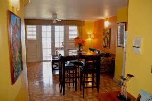a kitchen and dining room with a table and chairs at Seacastles by the beach/pool in Montego Bay