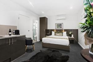 a hotel room with a large bed and a large window at North Adelaide Boutique Stays Accommodation in Adelaide
