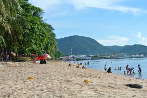 a group of people on a beach near the water at Baan Bang Saray Boutique3 in Chon Buri