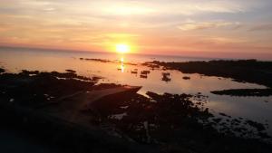 a sunset over a body of water with boats in it at Casa Carola in Oia