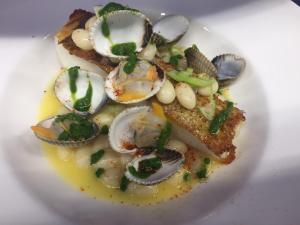 a plate of food with oysters and onions on a plate at Hotel-Restaurant Lann Roz / Côte Cuisine in Carnac