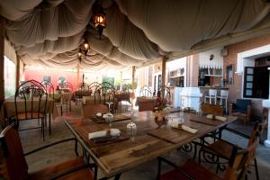 a dining room with a large table and chairs at Les 3 Métis in Antananarivo