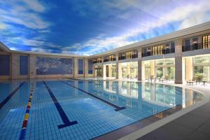 a large swimming pool in a large building at Xijiao State Guest Hotel in Shanghai