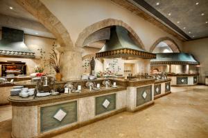 a large kitchen with a large island with sinks at Kempinski Hotel Soma Bay in Hurghada