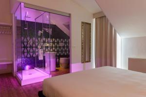 a bedroom with a purple lighted room with a bed at Elite Hotel & Spa in Mestre