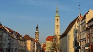 a city street with two tall towers and buildings at Ferienwohnung Luisenstraße in Görlitz