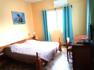 A bed or beds in a room at Hotel Chez Fanny