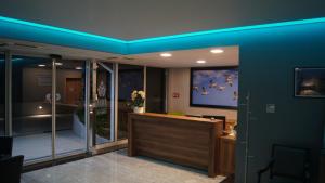 a lobby with a blue ceiling and a tv at Anna Hotel in Budapest +41 photos