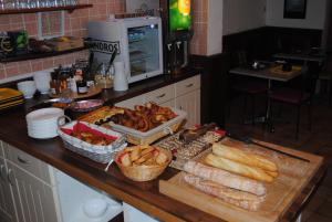a kitchen counter with a bunch of bread and other foods at Hôtel Le Goëlo - Port de Paimpol in Paimpol
