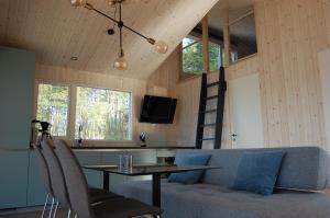 a living room with a table and a couch at Nisser Hyttegrend og Camping in Fjone