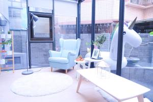 a room with a unicorn chair and a table at Greenight Hotel in Taichung