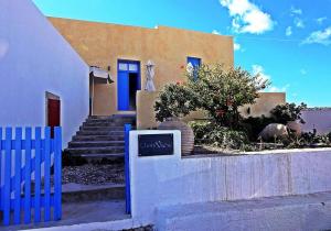 a house with a blue fence in front of it at Chora View in Kýthira