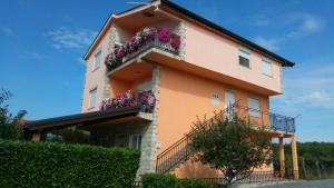 a building with flowers on the side of it at Rooms Mario in Međugorje