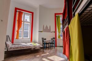 a room with a bed and a table in it at Pal's Mini Hostel in Budapest