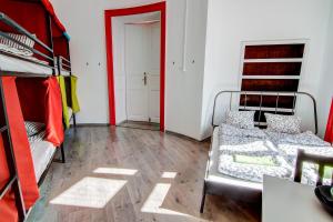 a room with two bunk beds and a table at Pal's Mini Hostel in Budapest