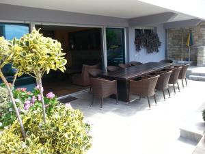 a wooden table and chairs on a patio at Apartment Nella Kostrena in Kostrena