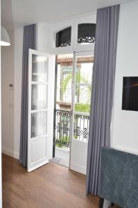 a room with a door open to a balcony at Edifício Charles 203 in Funchal