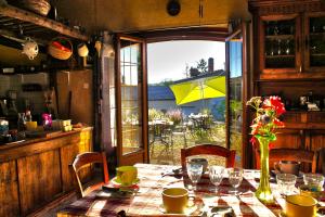a dining room table with a vase of flowers on it at la Passerelle in Chavagnes-en-Paillers
