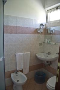 a bathroom with a toilet and a sink at Albergo La Marinella in Varazze +51 photos