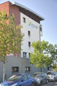 two cars parked in front of a building at L'Escale in Dunkerque