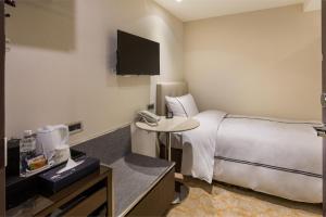 Postel nebo postele na pokoji v ubytování K Hotel Tianjin