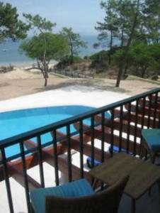 a balcony with a view of a swimming pool at Hotel Soltroia - Foz Do Sado in Troia