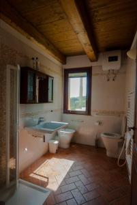 a bathroom with a sink and a tub and a toilet at Country House Il Tiglio in Mergo