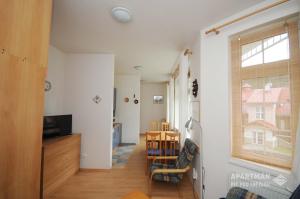 a living room with a television and a window at Apartmán Pec pod Sněžkou in Pec pod Sněžkou