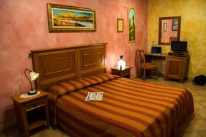 Postel nebo postele na pokoji v ubytování Agriturismo Tre Rondini