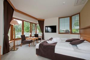 a bedroom with a large bed and a table and chairs at Lovecká Bašta in Strakonice