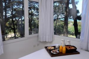 a tray of food on a counter next to a window at Jaina Resort & Spa in Mar de las Pampas