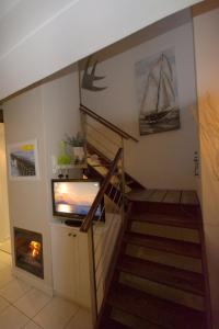 a living room with a staircase with a tv and a staircase at B4 Waterfront in Swakopmund