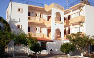 a white building with balconies on the side of it at Pentari in Stalos