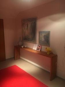 a room with a red rug and two paintings on the wall at Kress No.1 in Kehl am Rhein