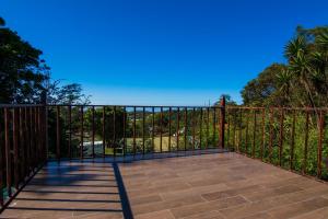 a balcony with a fence and a blue sky at Mar Inn Costa Rica in Monteverde Costa Rica